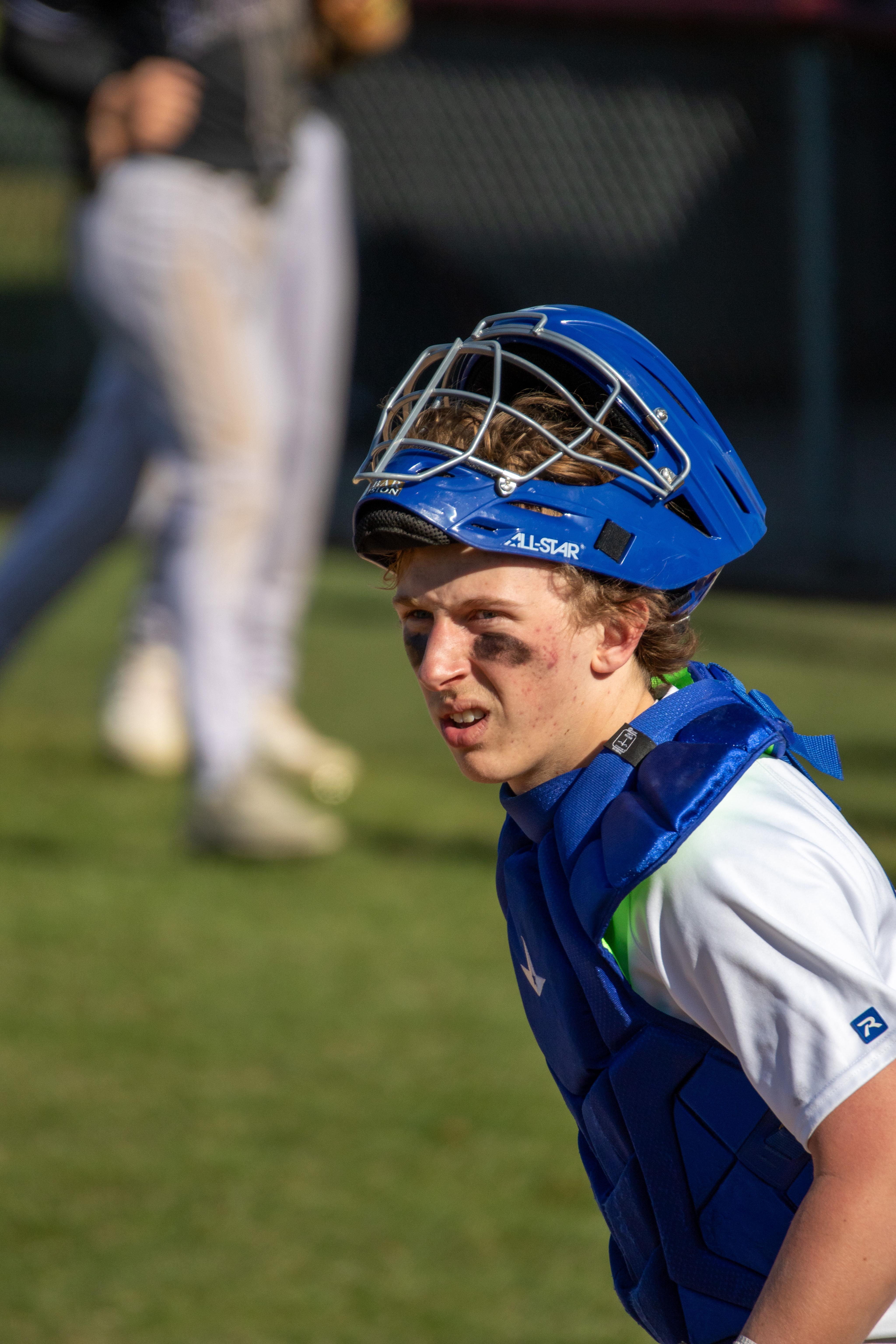 Washburn catcher in blue gear showing intensity during game